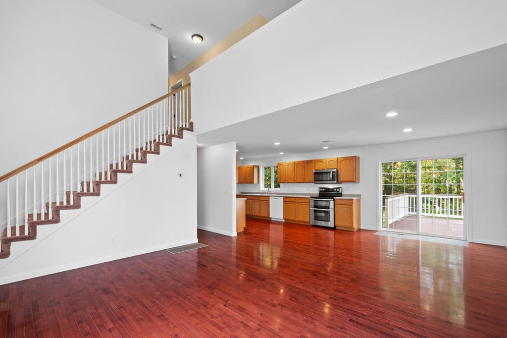 Living room looking toward the open stairs and kitchen